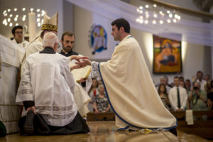 Bishop Thomas J. Olmsted anoints the hands of Fr. Ryan Lee during the priestly ordination Mass at St. Thomas Aquinas Parish in Avondale June 11. (Billy Hardiman/CATHOLIC SUN)