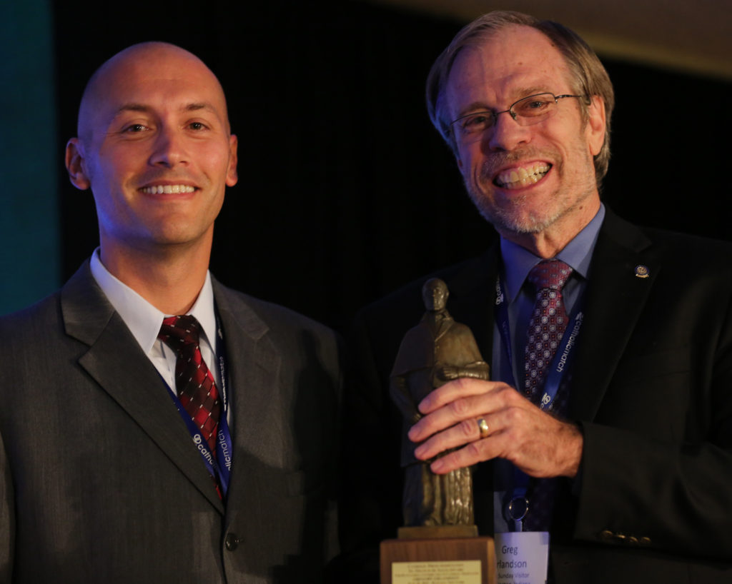 Rob DeFrancesco, past president of the Catholic Press Association, poses with Greg Erlandson, after the CPA presented Erlandson with the St. Francis de Sales Award June 26, 2015, during the Catholic Media Conference in Buffalo, N.Y. The award recognizing excellence in journalism is the highest honor given by the association. (CNS photo/Bob Roller)