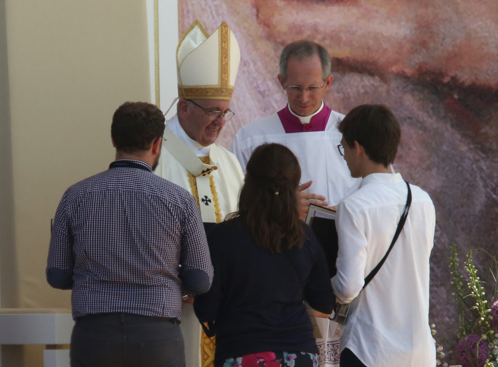 Pope Francis greets young people as he celebrates the World Youth Day closing Mass July 31 at the Field of Mercy in Krakow, Poland. (CNS photo/Bob Roller)