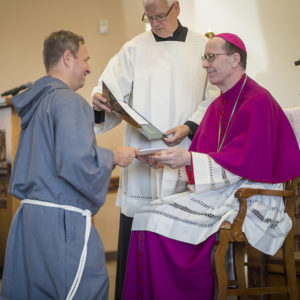 Fr. Bradley LePage receives his new religious name from Bishop Olmsted: Fr. Joseph Francis, FHS. (Billy Hardiman/CATHOLIC SUN)
