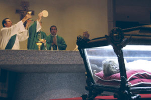 In this file photo, Bishop Thomas J. Olmsted holds the Host during a Mass he celebrated for pilgrims from Phoenix at St. John the Evangelist Parish in Philadelphia Sept. 25, 2015, for the World Meeting of Families. In front of the altar are the relics of St. Maria Goretti, which were on tour through the United States in anticipation of the Extraordinary Year of Mercy. (Justin Bell/CATHOLIC SUN)