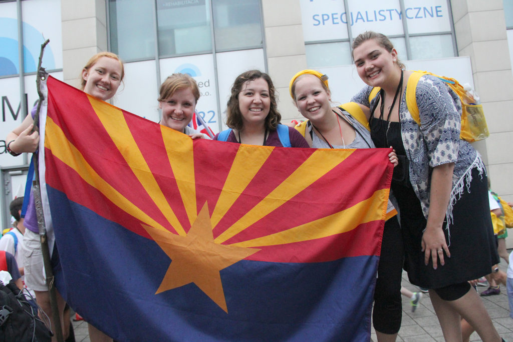 Pilgrims from St. Timothy Parish in Mesa hold in Arizona flag while in Krakow for World Youth Day. (Justin Bell/CATHOLIC SUN)