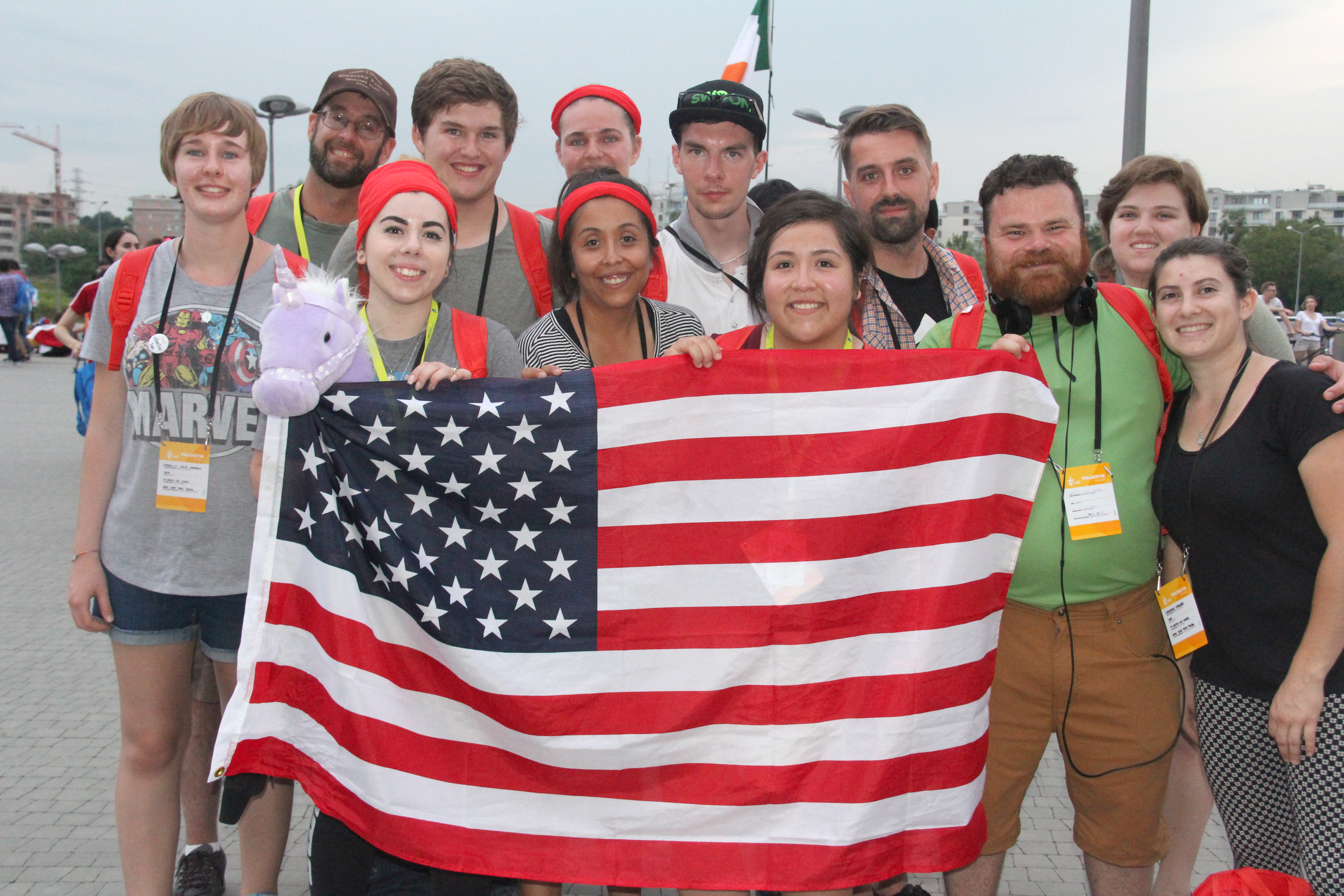 A group of pilgrims from Sacred Heart Parish in Prescott hold an American flag as they arrive in Krakow for World Youth Day. (Justin Bell/CATHOLIC SUN)