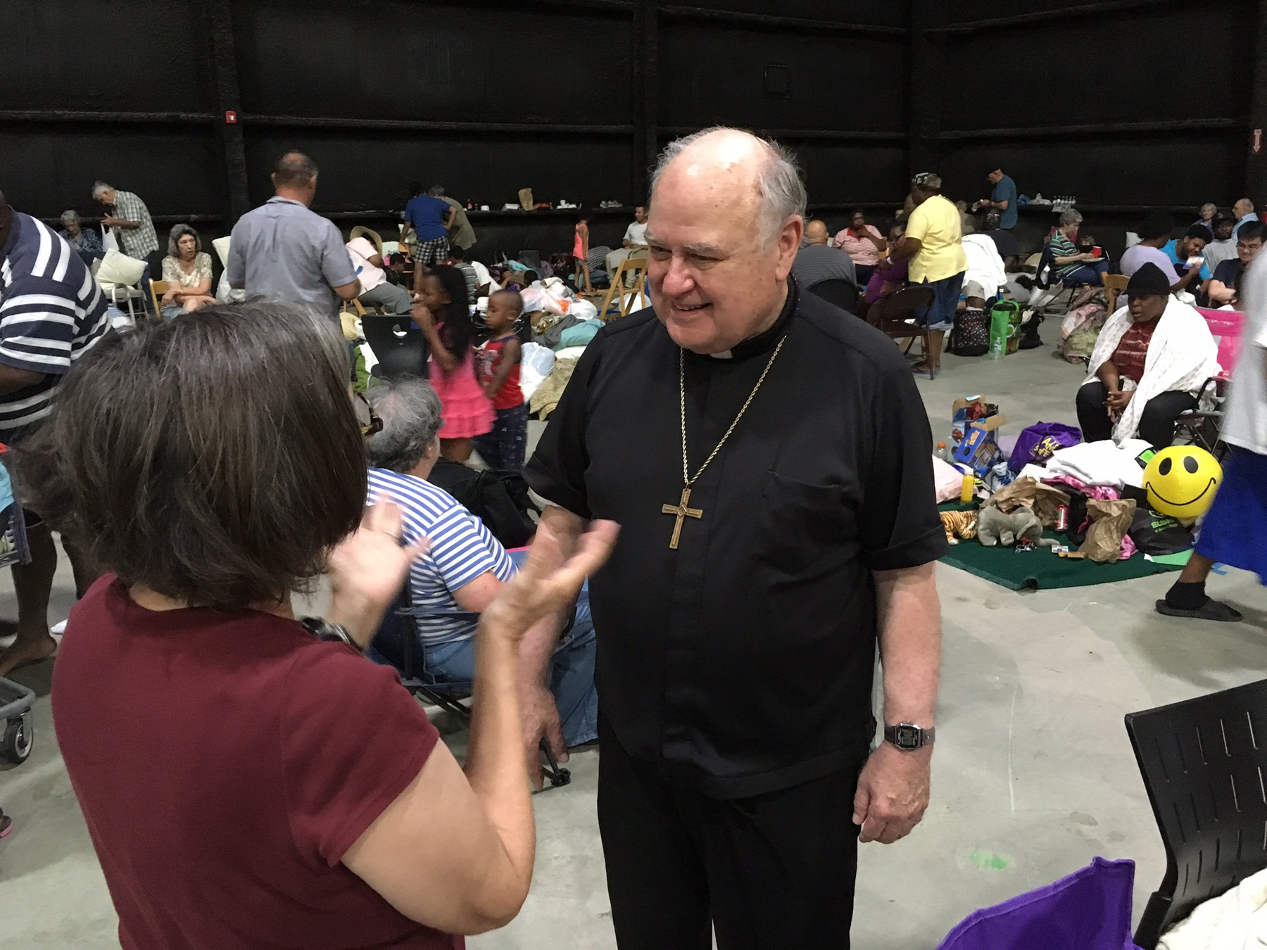 Bishop Robert W. Muench of Baton Rouge, La., visits an evacuation shelter Aug. 14. Thousands of people in the Diocese of Baton Rouge have been displaced because of extreme flooding. (CNS photo/courtesy Father Paul Yi)