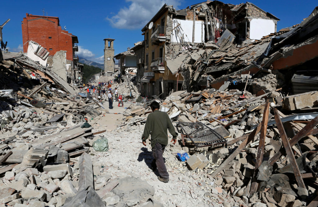 A man walks amid rubble following an earthquake in Amatrice, Italy, Aug. 24. (CNS photo/Remo Casilli, Reuters) 