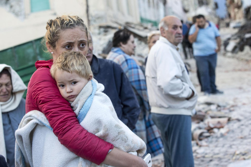 A mother embraces her son in Amatrice, Italy, following an earthquake Aug. 24. (CNS photo/Massimo Percossi, EPA)