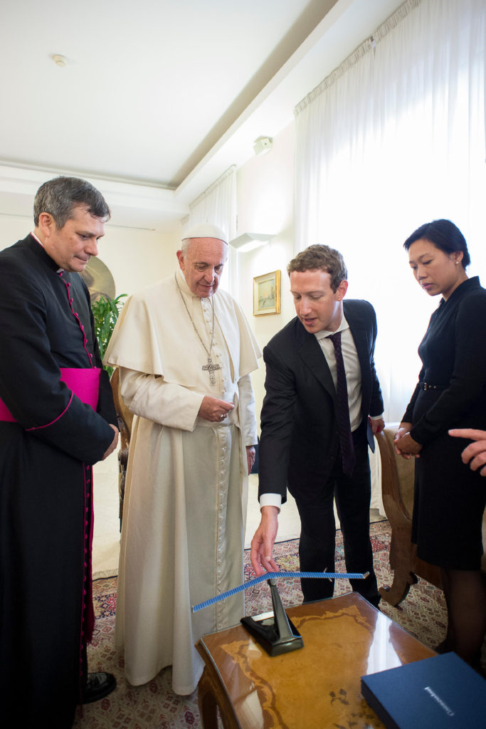 Pope Francis accepts a model aircraft from Mark Zuckerberg, CEO of Facebook, and his wife, Priscilla Chan, during a private audience at the Vatican Aug. 29. The model is of Aquila, a solar-powered aircraft being developed by Facebook to beam internet coverage to remote parts of the world. (CNS photo/L'Osservatore Romano, handout)