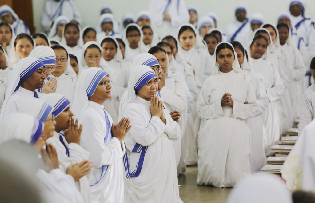 Members of the Missionaries of Charity pray Aug. 26 near the tomb of Blessed Teresa of Kolkata, India, in celebration of her birthday. Mother Teresa, founder of the Missionaries of Charity, will be canonized at the Vatican Sept. 4. (CNS photo/Piyal Adhikary, EPA) 