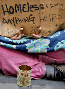 A homeless woman sits on a sidewalk in 2014 in New York City. Despite there being 46.7 million Americans living in poverty, there has been little talk about the needs of poor people on the presidential campaign trail. (CNS photo/Justin lane, EPA) 