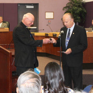Bullhead City Mayor Tom Brady presents the key to the city to Fr. Peter Dobrowski after the priest had given the invocation at the begnning of the April 19 City Council meeting. (Photo courtesy of Joe Anderson)