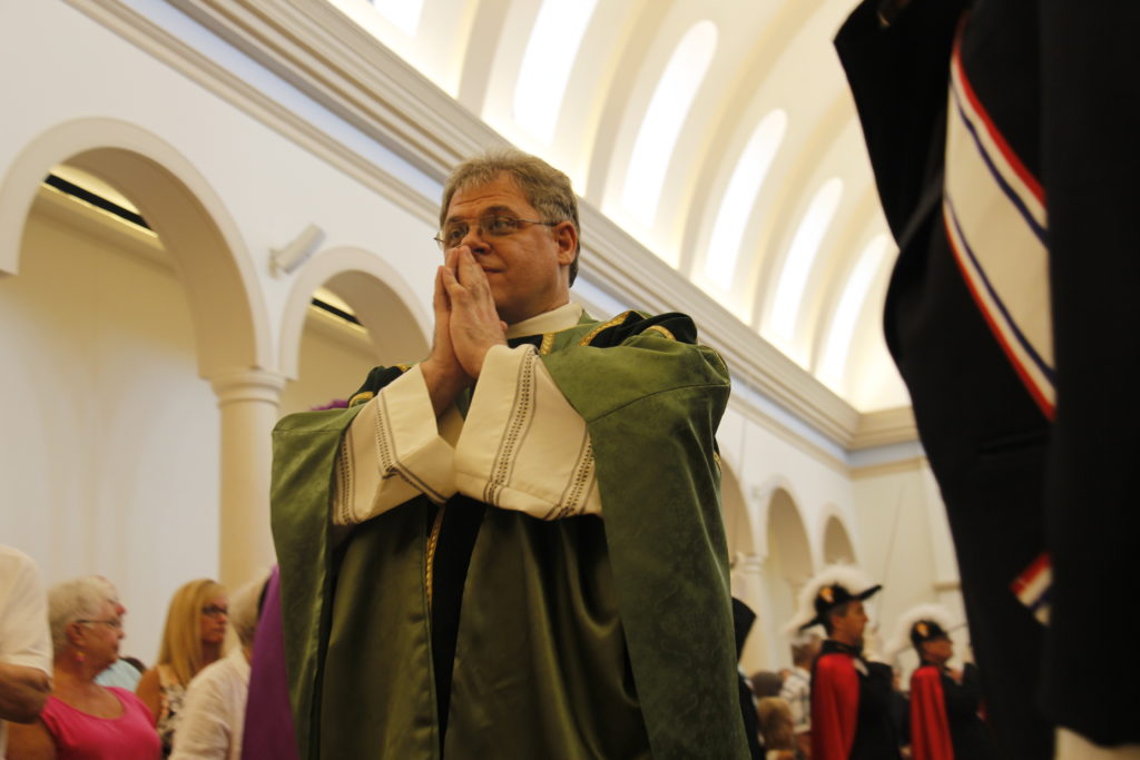 Fr. Peter Rossa, pastor of St. Bernadette Parish, processes into Mass Aug. 13. A parishioner asked him upon his arrival nine years ago about the reality of a new church. (Ambria Hammel/CATHOLIC SUN)