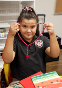 Among the school supplies third-graders at  St. Catherine of Siena unpacked their first day back Aug. 10 was a rosary. Whether it's prayer time in the chapel, in the classroom or discussing social justice, the faith remains an integral part of a Catholic education. (Ambria Hammel/CATHOLIC SUN)