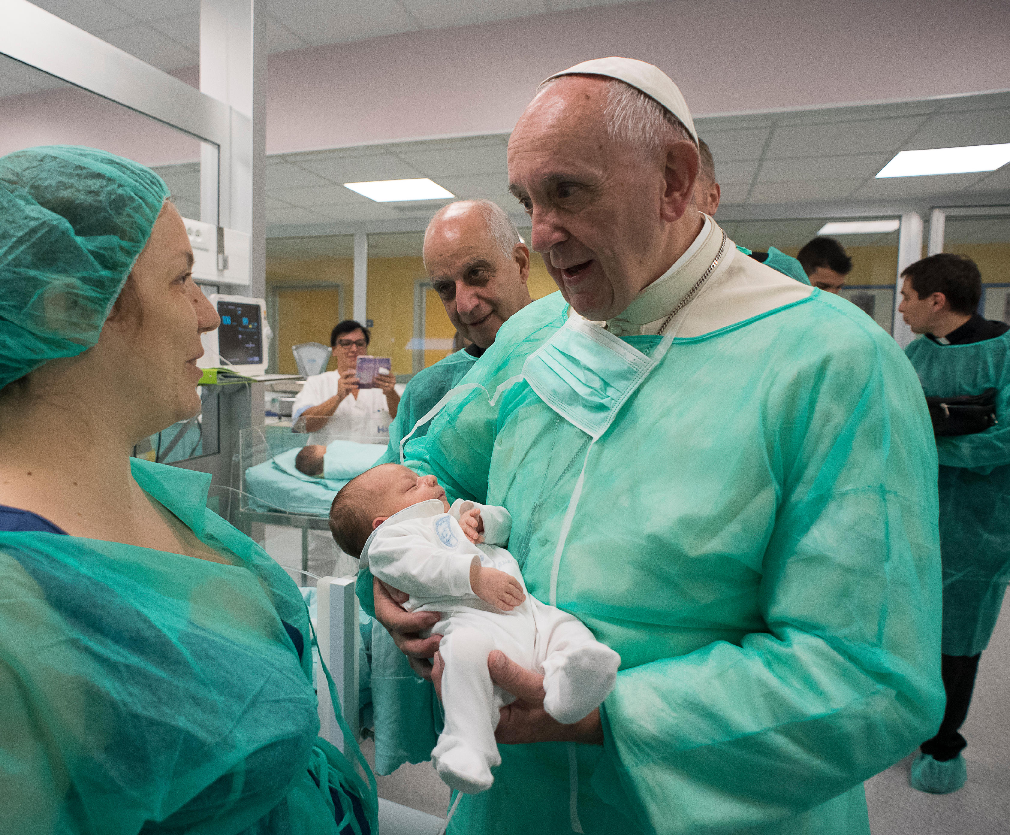 Pope Francis holds a baby as he visits the neonatal unit at San Giovanni Hospital in Rome Sept. 16. The visit was part of the pope's series of Friday works of mercy during the Holy Year. (CNS photo/L'Osservatore Romano, handout)