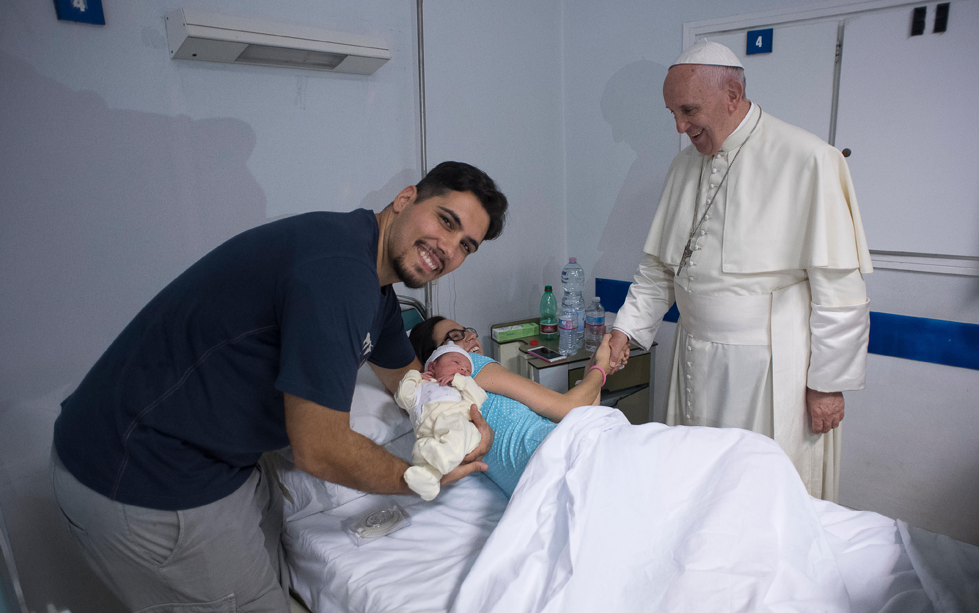 Pope Francis greets a mother as he visits the neonatal unit at San Giovanni Hospital in Rome Sept. 16. The visit was part of the pope's series of Friday works of mercy during the Holy Year. (CNS photo/L'Osservatore Romano, handout)
