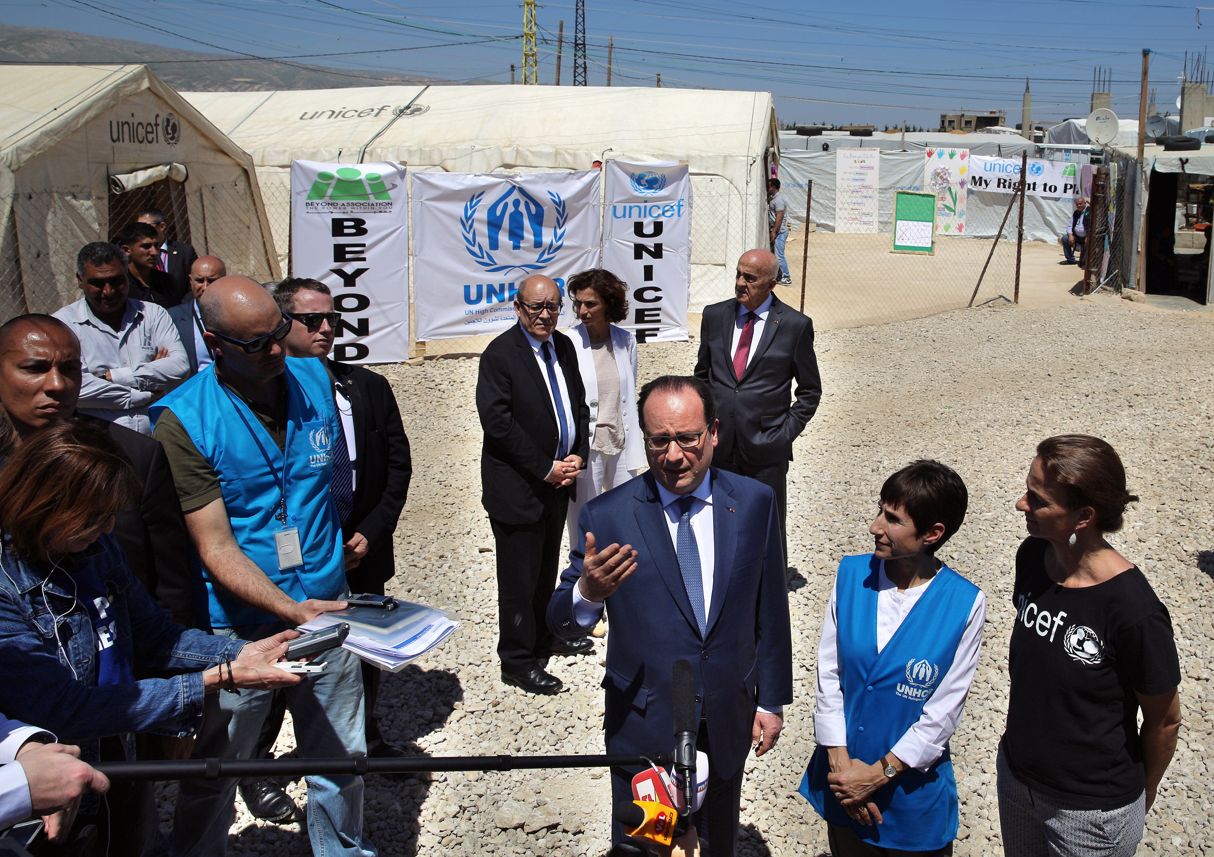 French President Francois Hollande speaks to journalists during a visit to a camp for Syrian refugees in mid-April in Lebanon's Bekaa Valley. Journalists must not foment fear when covering issues or events such as forced migration due to war or famine, Pope Francis said. (CNS photo/Bilal Hussein pool via EPA)