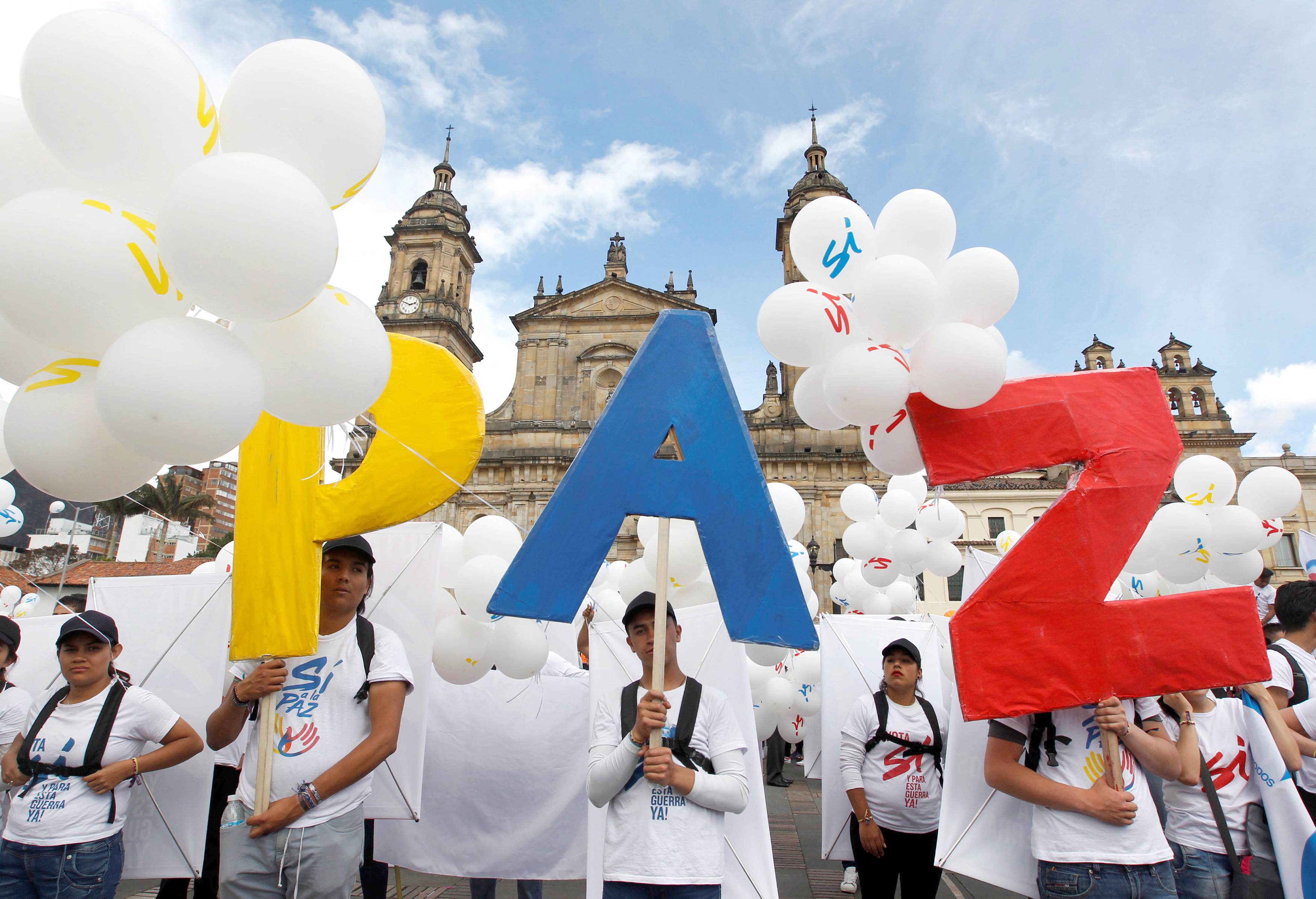 People form the word Peace outside the cathedral Sept. 26 in Bogota, Colombia. To chants of "No more war," the Colombian government and Marxist rebels signed an agreement that day to end Latin America's last armed conflict. (CNS photo/Felipe Caicedo, Reuters)