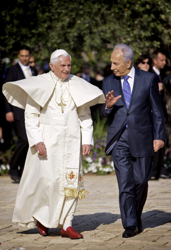 Pope Benedict XVI and Israeli President Shimon Peres walk in the garden of the presidential palace in 2009 in Jerusalem. Peres, who dedicated himself to the work of achieving peace during the last years of his life, died Sept. 28 at age 93. (CNS photo/Oded Balilty, Reuters)