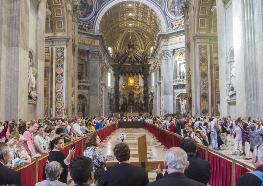 Leaders of Hispanic ministry in the United States carry the V Encuentro cross to the tomb of St. Peter in St. Peter’s Basilica Sept. 26 at the Vatican. The leaders were on a five-day pilgrimage to the Vatican in preparation for launching the four-year Encuentro process in the United States. (CNS photo/Robert Duncan) 