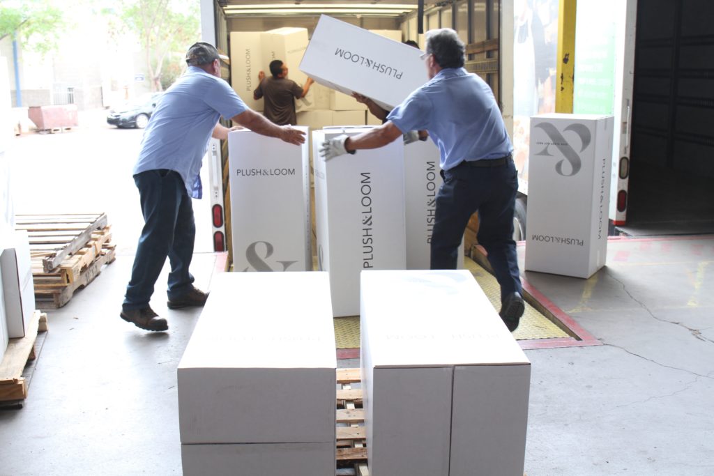 Plush & Loom unloads rolled up mattresses at St. Vincent de Paul's main campus Sept. 7. The donation was the first deliver through the new company's "Give Sleep. Get Rest" program. (photo courtesy of St. Vincent de Paul)