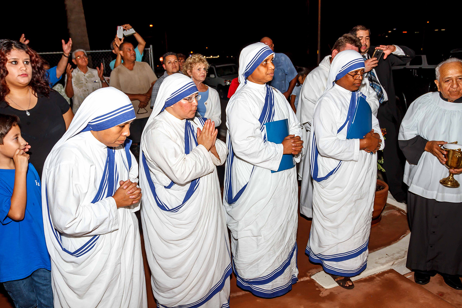 The four Missionaries of Charity serving in Phoenix look on as Bishop Olmsted blesses the three markers indicating the spots where Mother Teresa kissed the ground. (John Bering/CATHOLIC SUN)