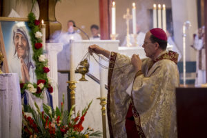Bishop Thomas J. Olmsted incenses an image and relic of St. Mother Teresa at Ss. Simon and Jude Cathedral Sept. 4, hours after she was canonized in Rome. (Billy Hardiman/CATHOLIC SUN)
