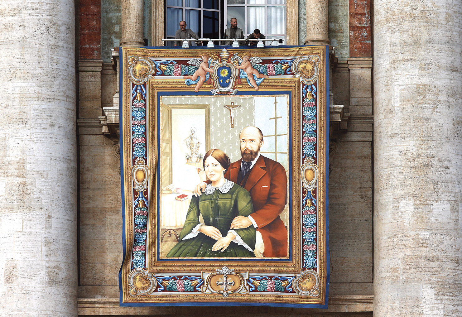 A banner of Ss. Louis and Marie Zelie Guerin Martin hangs on the facade of St. Peter’s Basilica at the Vatican in this 2015 file photo. The parents of St. Thérèse of Lisieux were the first married couple to be canonized together on Oct. 18 of that year. (Paul Haring/CNS)