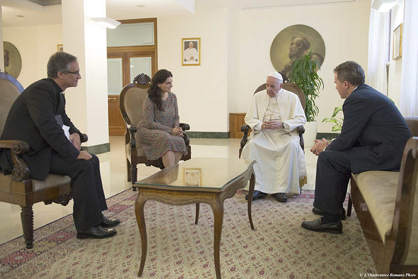 Pope Francis talks with Msgr. Dario Viganò, director of the Vatican Secretariat for Communications (far left), Paloma García Ovejero, vice director of the Vatican press office (center left) and Greg Burke, director of the Vatican press office, (far right), at the Vatican in this July 11 file photo. The Vatican announced Sept. 26 that Pope Francis chose the theme “‘Fear not, for I am with you.’ Communicating hope and trust in our time,” for World Communicantions Day 2017. (CNS photo/L’Osservatore Romano, handout)