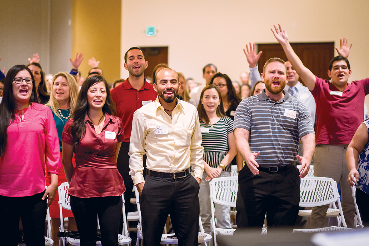 A group of young adults cheer while filiming a video at the Young Catholic Professionals launch at St. Francis Xavier Parish Aug. 23. (Billy Hardiman/CATHOLIC SUN)