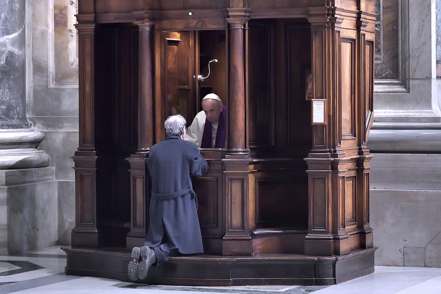 Pope Francis hears confessions during a Lenten penance service in St. Peter's Basilica at the Vatican March 13. During the service the pope announced an extraordinary jubilee, a Holy Year of Mercy, to be celebrated from Dec. 8, 2015, until Nov. 20, 2016. (CNS photo/Stefano Spaziani, pool)