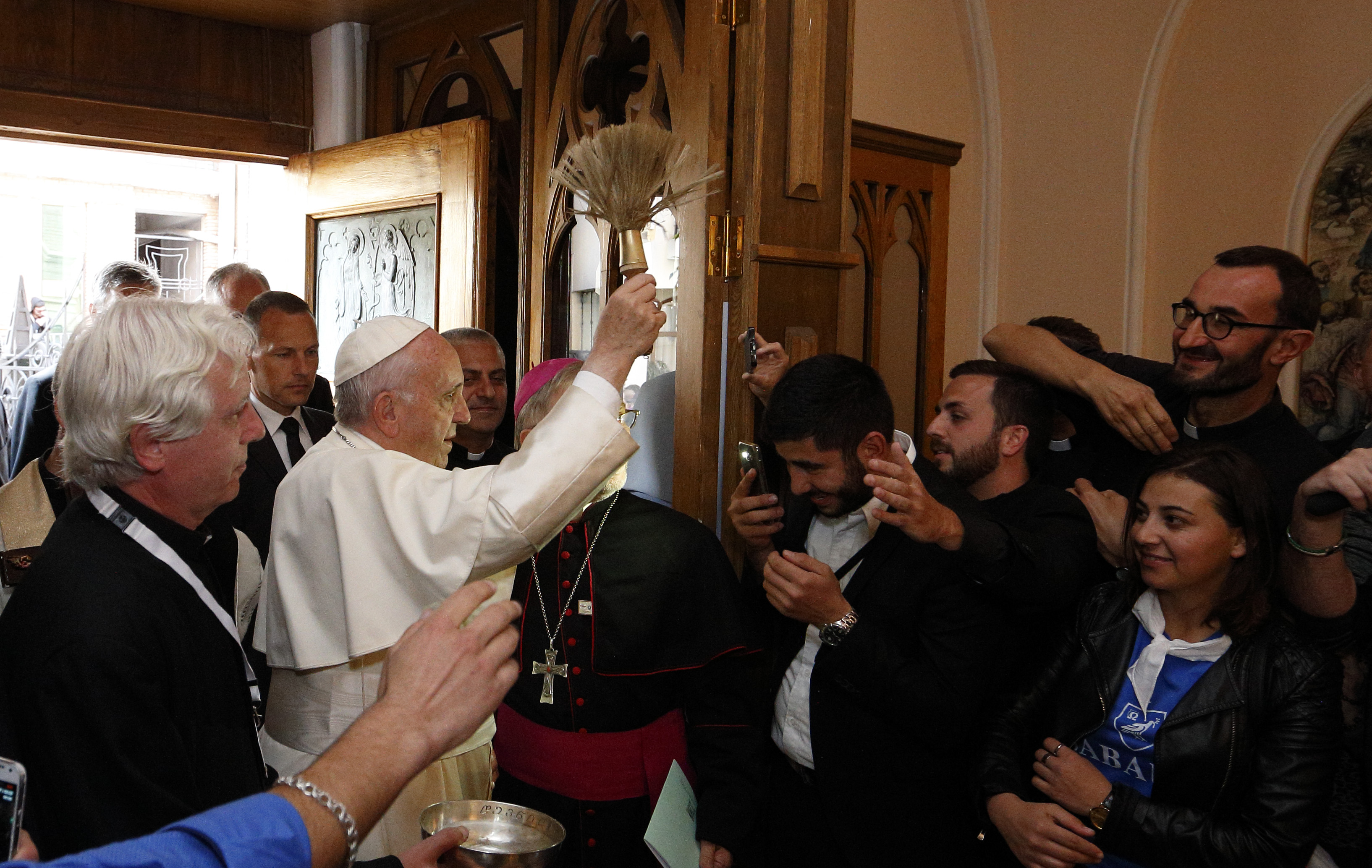 Pope Francis blesses people with holy water as he arrives for a meeting with priests, men and women religious, seminarians and pastoral workers at the Church of the Assumption in Tbilisi, Georgia, Oct. 1. (CNS photo/Paul Haring)