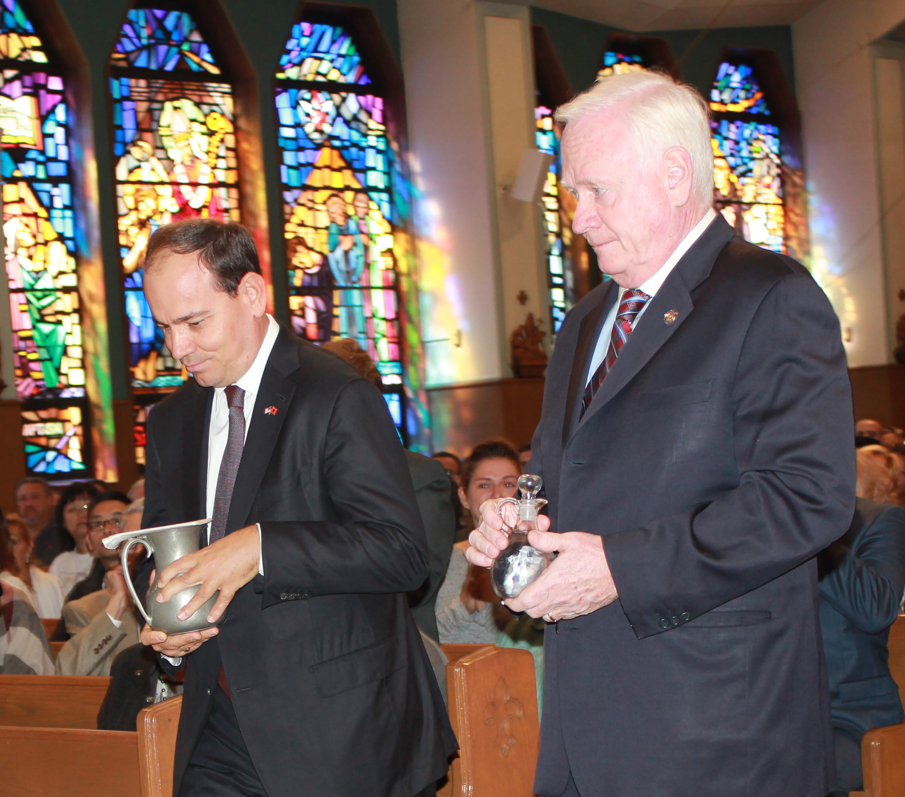Albanian President Bujar Nishani and state Sen. Martin Golden of Brooklyn, N.Y., carry up the offertory gifts during Mass Sept. 25 at St. Athanasius Church in Brooklyn. President Nishani later joined local Albanian-Americans, clergy and elected officials in unveiling a statue of St. Teresa of Kolkata, a gift to Brooklyn from the Albanian community. (CNS photo/Marie Elena Giossi, The Tablet)
