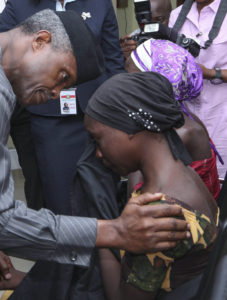 Nigerian Vice President Yemi Osinbajo consoles one of the 21 released Chibok girls Oct. 13 in Abuja. Three Catholic leaders welcomed the release of some of the girls kidnapped in 2014 from a school in Chibok and urged the Nigerian government to prioritize the release of the remaining girls. (CNS photo/EPA) 
