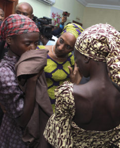 Oludolapo Osinbajo, wife of Nigerian Vice President Yemi Osinbajo, consoles one of the 21 released Chibok girls Oct. 13 in Abuja. Three Catholic leaders welcomed the release of some of the girls kidnapped in 2014 from a school in Chibok and urged the Nigerian government to prioritize the release of the remaining girls. (CNS photo/EPA) 