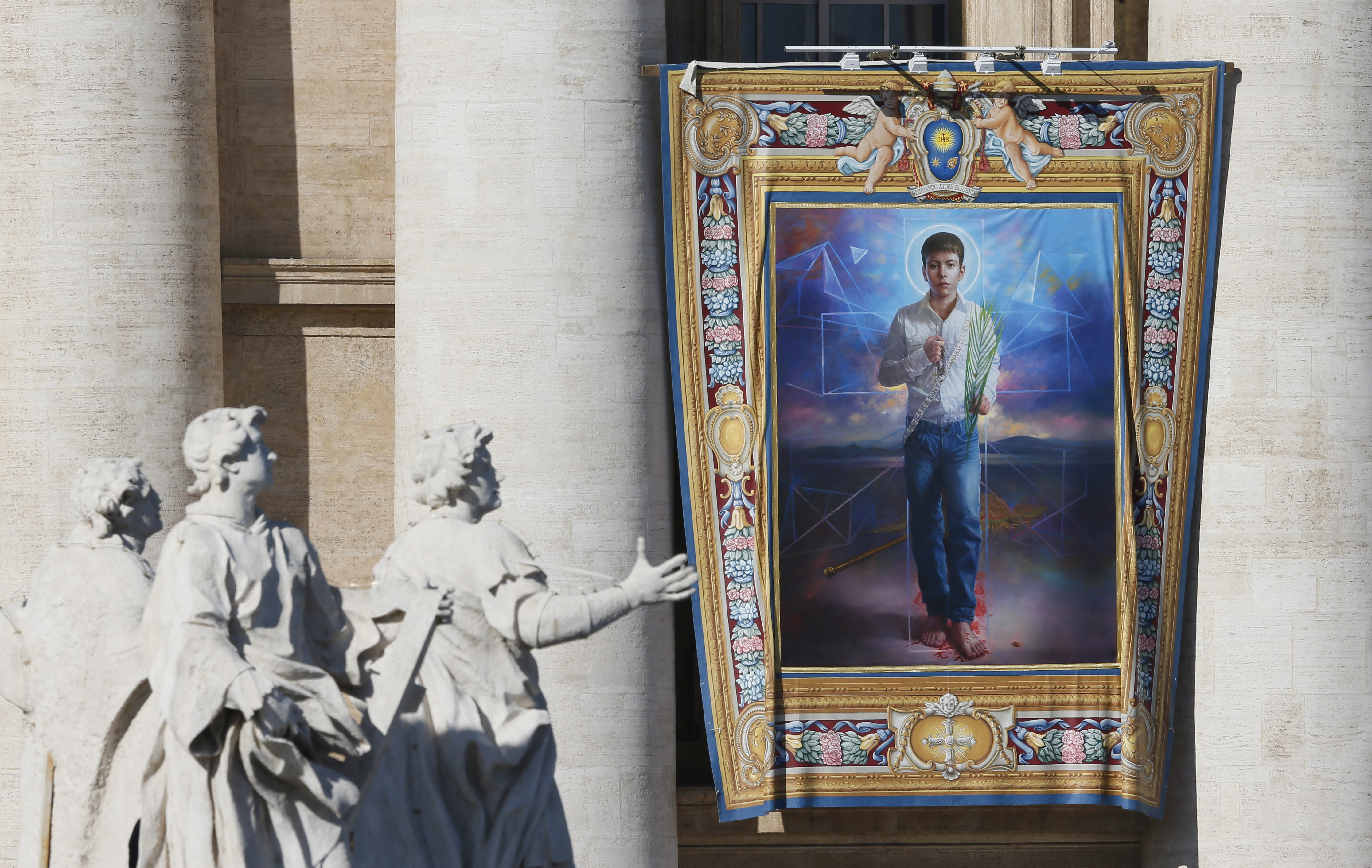 A tapestry of new Mexican St. Jose Sanchez del Rio, who was martyred at the age of 14 in 1928, hangs from the facade of St. Peter's Basilica before the canonization Mass for seven new saints celebrated by Pope Francis at the Vatican Oct. 16. (CNS photo/Paul Haring)