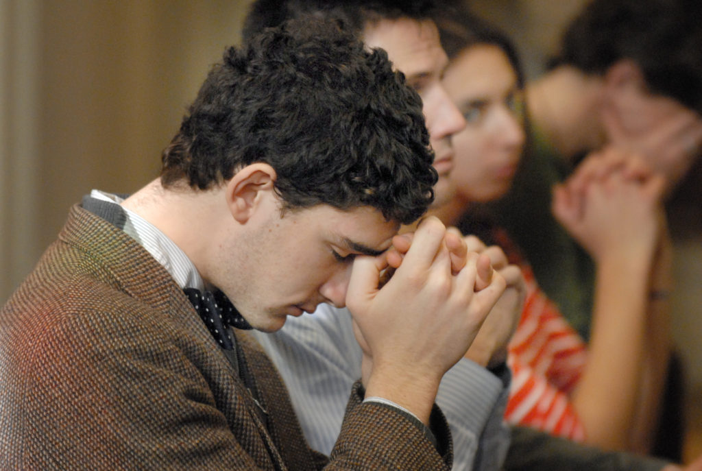 A young man prays during a novena in 2010 at The Catholic University of America in Washington. The Knights of Columbus is urging its members and other U.S. Catholics to pray a novena from Oct. 30 to Nov. 7, the eve of Election Day. (CNS photo/Rafael Crisostomo, El Pregonero) 