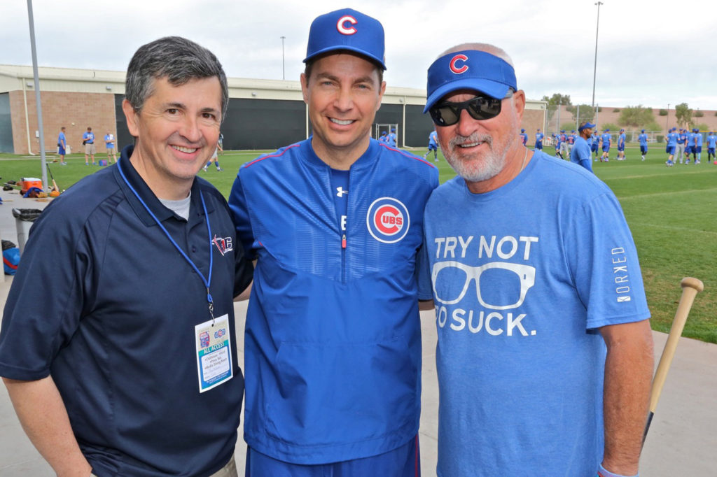 Fr. Burke Masters, center, the Chicago Cubs' Catholic chaplain, poses with Ray McKenna, left, founder of Catholic Athletes for Christ, and Cubs Manager Joe Maddon during Cubs spring training in March 2016 at Sloan Park in Mesa, Ariz. (CNS photo/Ed Mailliard, courtesy Topps) 