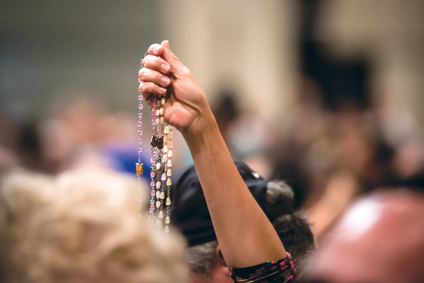 A woman holds up her rosaries to be blessed at the 40th annual Rosary Celebration held Sunday, Oct. 25 at the Phoenix Convention Center.