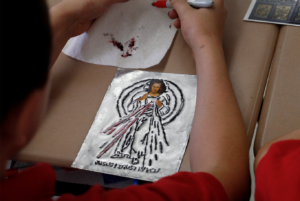 A sixth-grader woks on his Divine Mercy art project at Our Lady of Mount Carmel School Sept. 29. (Ambria Hammel/CATHOLIC SUN)