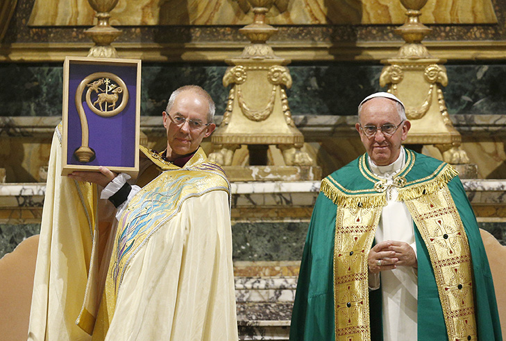 Anglican Archbishop Justin Welby of Canterbury, England, spiritual leader of the Anglican Communion, holds a replica of the staff of St. Gregory the Great given by Pope Francis at a vespers service at the Church of St. Gregory in Rome Oct. 5. (CNS photo/Paul Haring)