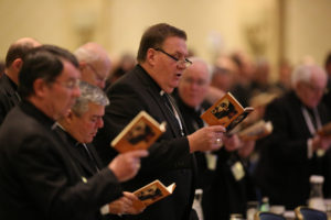 Cardinal-designate Joseph W. Tobin of Indianapolis, center, joins other bishops during morning prayer Nov. 15 at the annual fall general assembly of the U.S. Conference of Catholic Bishops in Baltimore. (CNS photo/Bob Roller) 