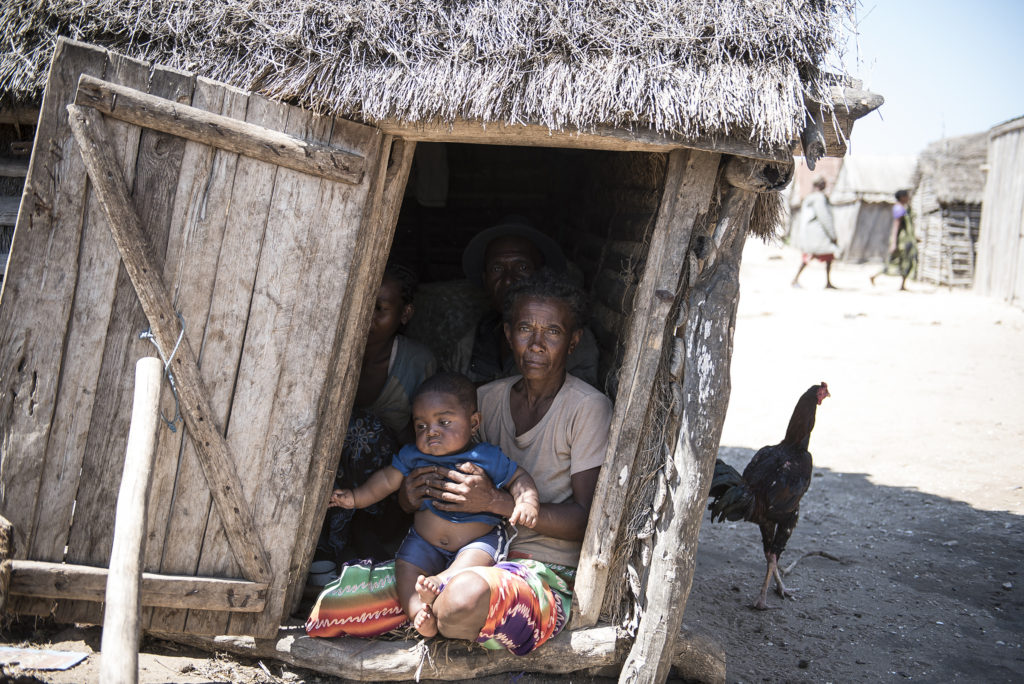 A family sits inside their hut in Ambovombe, Madagascar, Sept. 22, 2015. Hunger levels are now so severe in drought-ridden southern Madagascar that many people in remote villages have eaten almost nothing but cactus fruit for up to four years, said a Catholic Relief Services official. (CNS photo/Shiraaz Mohamed, EPA) 