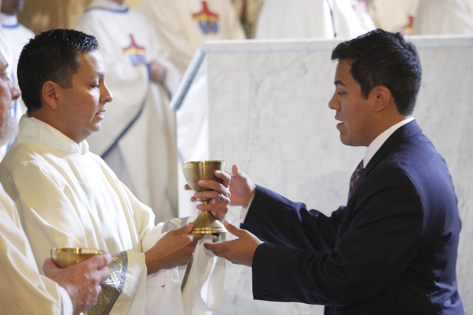 Dcn. Billy Chavira gives the Precious Blood to his son for the first time as a deacon at his ordination Mass at Ss Simon and Jude Cathedral Nov. 5. Dcn. Chavira will be serving at St. Thomas the Apostle Parish.