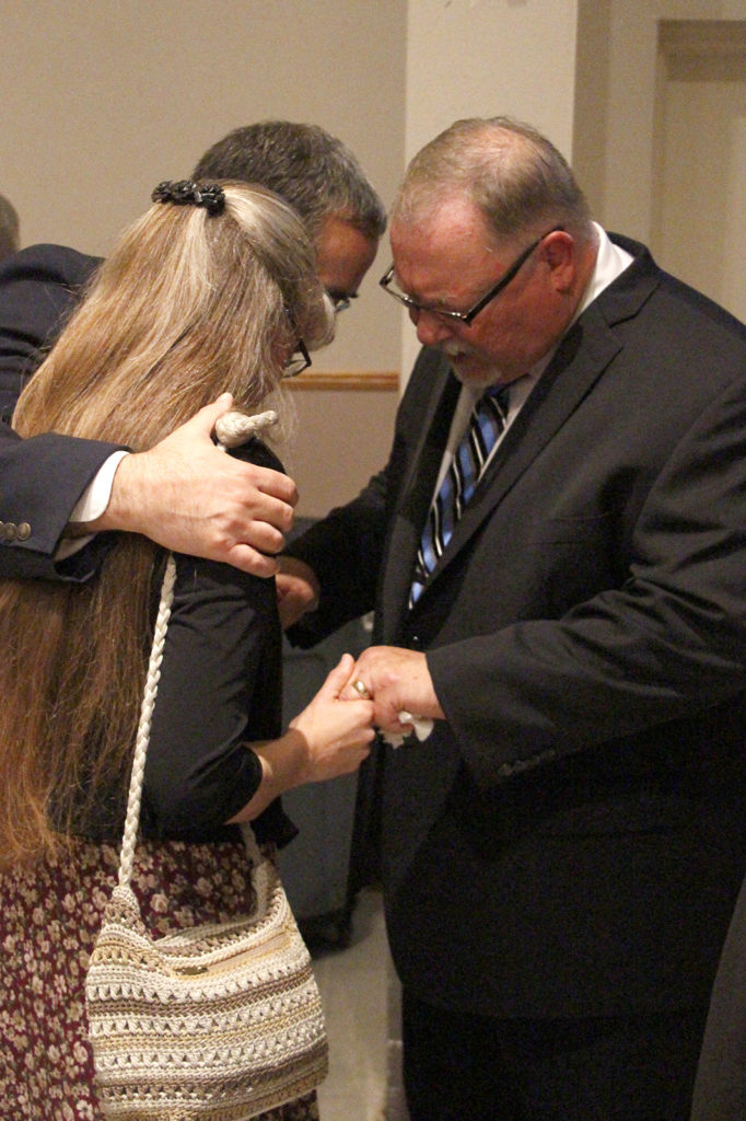 The newly ordained Dcn. Chris Giannola blesses a couple at a reception after his ordination Mass Nov. 5. (Ambria Hammel/CATHOLIC SUN)