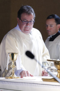 Newly ordained Dcn. Gary Scott helps prepare the altar for the Liturgy of the Eucharist moments after he was ordained to the permanent diaconate Nov. 5. (Ambria Hammel/CATHOLIC SUN)