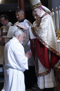 Bishop Olmsted lays hands on Tony Smith, ordaining him to the permanent diaconate Nov. 5 at Ss. Simon and Jude Cathedral. (Ambria Hammel/CATHOLIC SUN)