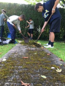 Catholic school students from the Diocese of Phoenix took their volunteer work to Ireland by cleaning pathways in a cemetery. They are Seamus Simmons, an eighth-grader at Ss. Simon and Jude, Jude Foster, a fourth-grader at St. Theresa, Ben Prebil, a Ss. Simon and Jude eighth-grader and his older brother, Nick, a freshman at Brophy College Preparatory. (courtesy photo)