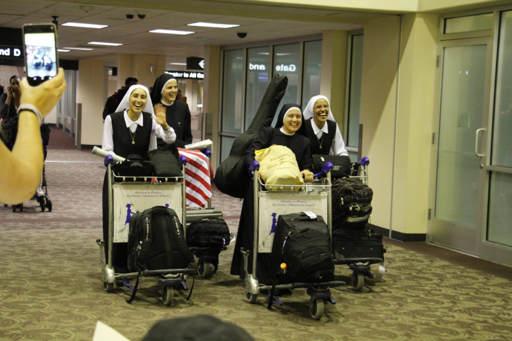 Four Servants of the Plan of God emerge from Terminal 2 at Sky HArbor International Airport Oct. 28. The sisters will serve at Our Lady of Mount Carmel Parish and School plus outreaches at nearby Arizona State University via St. Paul's Outreach and the All Saints Catholic Newman Center. (Ambria Hammel/CATHOLIC SUN)