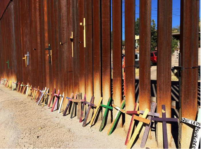 Wooden crosses in Nogales, Mexico, lean on the border fence with the United States Nov. 10. The crosses represent lives lost during migration. (CNS photo/David Alire Garcia, Reuters)