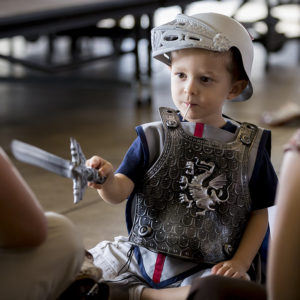 A young man dressed as fourth-century martyr St. George prepares to do battle with a dragon. (Billy Hardiman/CATHOLIC SUN)