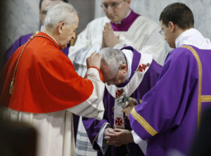 Pope Francis receives ashes from Slovakian Cardinal Jozef Tomko during the 2014 Ash Wednesday Mass at the Basilica of Santa Sabina in Rome. (CNS photo/Paul Haring) 
